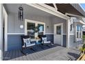 Inviting front porch featuring rocking chairs, a stylish awning, and a welcoming entrance at 2206 S Ellsworth Rd # 157B, Mesa, AZ 85209