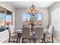 Bright dining room with a large window and an elegant chandelier at 26774 W Piute Ave, Buckeye, AZ 85396