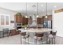 Gourmet kitchen featuring a large island with bar seating and pendant lighting at 26774 W Piute Ave, Buckeye, AZ 85396