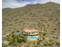 Luxury hillside home featuring a pool, desert landscape, and tennis court at 36879 N 38Th St, Cave Creek, AZ 85331