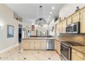 Open kitchen featuring granite counters, stainless steel appliances, and an island with bar seating, perfect for entertaining at 4502 E Hartford Ave, Phoenix, AZ 85032