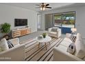 Bright living room features contemporary furniture, a ceiling fan, and sliding glass doors to the patio at 4806 N 186Th Ln, Goodyear, AZ 85395