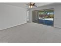 Spacious living area boasts natural light through sliding glass doors to the patio and neutral carpet at 4806 N 186Th Ln, Goodyear, AZ 85395