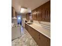 Kitchen with bright lighting, dark brown cabinets, and white wall shelves at 502 W 11Th St, Casa Grande, AZ 85122