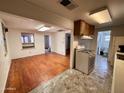 Bright eat-in kitchen featuring an open floor plan, and a view of the bathroom and living room at 502 W 11Th St, Casa Grande, AZ 85122