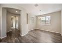 Bright dining area with an elegant lighting fixture and wood floors at 5628 S Winchester --, Mesa, AZ 85212
