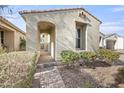Inviting front entry featuring a covered walkway and professionally landscaped yard with vibrant shrubs at 5628 S Winchester --, Mesa, AZ 85212
