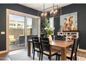 Dining room with modern light fixture, leading to outdoor patio through sliding glass door at 6858 E Orion Dr, Scottsdale, AZ 85257