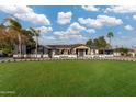 Expansive single-story home with a large, green lawn and a circular driveway lined with manicured landscaping at 7014 E Palo Verde Ln, Paradise Valley, AZ 85253