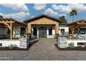 Stunning home entrance with a striking wooden gable and an inviting brick pathway to the custom double doors at 7014 E Palo Verde Ln, Paradise Valley, AZ 85253