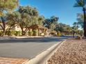 View of the community guard house surrounded by mature trees and manicured landscaping at 9707 E Mountain View Rd # 1456, Scottsdale, AZ 85258