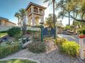 Welcome sign to the Racquet Club, surrounded by lush landscaping and a charming bridge at 9707 E Mountain View Rd # 1456, Scottsdale, AZ 85258
