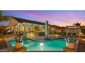Inviting backyard with pool, outdoor kitchen, covered patio, and desert landscaping at 10455 E Thatcher Ave, Mesa, AZ 85212