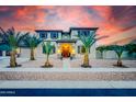 Beautiful home exterior featuring decorative stone, lush landscaping, and a welcoming entrance at 11737 N 143Rd Dr, Surprise, AZ 85379