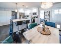 Open concept living space with modern furnishings, a dining area, and a view of the kitchen at 1207 E Alice Ave, Phoenix, AZ 85020