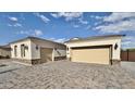 Beautiful single-Gathering home featuring a wide driveway and attached garages at 1586 N Himosa Dr, Casa Grande, AZ 85122