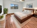 Bed with a wood frame, soft rug and a large window for great light at 17649 W Young St, Surprise, AZ 85388