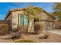 Lovely single-story home featuring desert landscaping, a welcoming entryway, and an attached two-car garage at 21198 W Berkeley Rd, Buckeye, AZ 85396