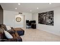 Spacious living room featuring tile floors, neutral walls, and comfortable brown leather furniture at 2327 E Pebble Beach Dr, Tempe, AZ 85282
