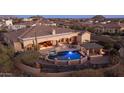 Expansive backyard aerial view with a pool, spa, outdoor seating, and desert landscaping at 2330 N Channing --, Mesa, AZ 85207