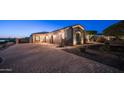 Paver driveway showcasing three-car garage and stone exterior accents with manicured landscaping at 2330 N Channing --, Mesa, AZ 85207