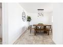 Bright dining area featuring a modern light fixture and rustic wooden table with bench seating at 3726 S Juniper St, Tempe, AZ 85282