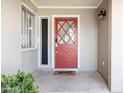 Inviting front entrance featuring a red door, sidelight and a 'hello' doormat at 3726 S Juniper St, Tempe, AZ 85282