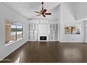 Bright living room featuring a fireplace, built-in shelving, and ample natural light at 3732 E South Fork Dr, Phoenix, AZ 85044