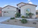 Charming single Gathering home with a two car garage and desert landscaping at 385 N Mataclor Ct, Casa Grande, AZ 85194