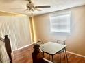 Dining area with laminate wood floors, natural light, and a simple table setup at 4065 E University Dr # 271, Mesa, AZ 85205
