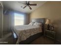 Comfortable bedroom with vaulted ceiling, large window for natural light, carpet and ceiling fan at 650 N Hawes Rd # 4834, Mesa, AZ 85207