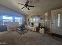 Cozy living room with vaulted ceilings, neutral carpet, sofas and large windows for natural light at 650 N Hawes Rd # 4834, Mesa, AZ 85207