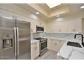 Updated kitchen features stainless steel appliances, quartz countertops, modern cabinets, and recessed lighting at 7710 E Gainey Ranch Rd # 140, Scottsdale, AZ 85258