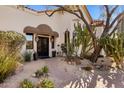 Inviting entrance with a paved walkway, wrought iron doors, and lush desert landscaping at 9370 E Calle De Las Brisas --, Scottsdale, AZ 85255