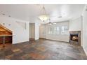 Open-concept living room with a cozy fireplace, unique flooring and lots of natural light at 10757 N 74Th St # 1016, Scottsdale, AZ 85260