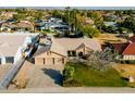 Aerial view of a single-story home with a well-maintained yard, pool and a three-car garage in a residential neighborhood at 15217 N 60Th St, Scottsdale, AZ 85254