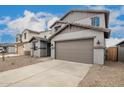 The two-story home boasts a two car garage and low maintenance desert landscaping at 18433 W Monte Lindo Ln, Surprise, AZ 85387
