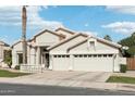 Attractive single-story home featuring a two-car garage, xeriscaping, and a covered front entrance at 2032 E Sierra Madre Ave, Gilbert, AZ 85296