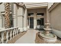Inviting front entrance with a water feature, tiled walkway, and a cozy seating area at 2032 E Sierra Madre Ave, Gilbert, AZ 85296