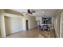 Spacious living area with neutral paint, tile floors, and dining space, offering a versatile layout at 23167 W Lasso Ln, Buckeye, AZ 85326