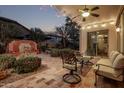 Covered patio with ceiling fan, tiled flooring, outdoor furniture, and a decorative water feature in the backyard at 3401 E Isaiah Ave, Gilbert, AZ 85298