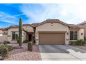 Charming home showcasing desert landscaping and a neutral-toned exterior with a spacious two-car garage at 3401 E Isaiah Ave, Gilbert, AZ 85298