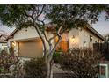 View of the exterior showcasing the attached two-car garage, desert landscaping, and neutral color palette at 3401 E Isaiah Ave, Gilbert, AZ 85298