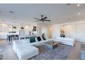 Open-concept living room with modern decor, wood floors, and seamless flow into the kitchen at 3706 E Ravenswood Dr, Gilbert, AZ 85298