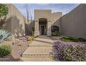 Inviting desert home featuring a tranquil walkway, desert landscaping, and a private front entrance at 38820 N 10Th St, Phoenix, AZ 85086