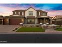 Stately two-story home featuring a three-car garage and manicured lawn at 3930 E Enrose St, Mesa, AZ 85205