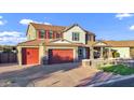 Expansive home featuring a brick driveway, three-car garage and a lush lawn at 3930 E Enrose St, Mesa, AZ 85205