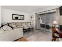 Bright living room features neutral tones, comfortable seating, and sliding glass doors to outdoor space at 4444 E Paradise Village N Pkwy # 132, Phoenix, AZ 85032
