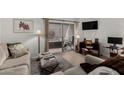 Inviting living room features contemporary decor and a sliding glass door leading to an outdoor space at 4444 E Paradise Village N Pkwy # 132, Phoenix, AZ 85032