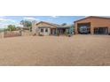Spacious backyard featuring a covered patio and detached garage with ample parking space at 508 N Sierra Vista Dr, Wickenburg, AZ 85390
